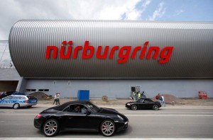 A car passes the newly built event centre of the Nuerburgring race course